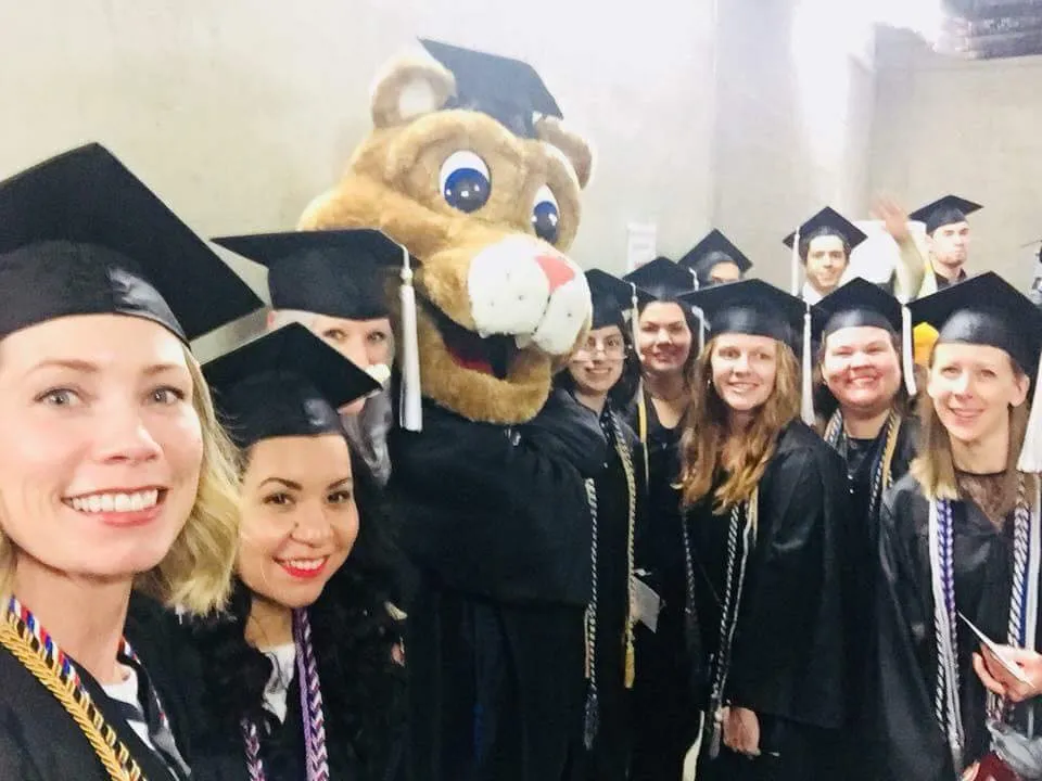 UCCS Psychology students with Clyde the mascot at graduation.