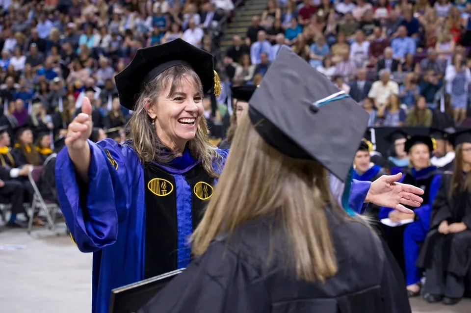 UCCS Psychology professor with student at graduation.